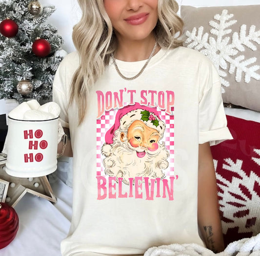 Celebrate the season with this Christmas graphic tee in pink - 'Believe Santa womens christmas graphic tees