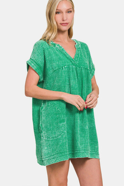 Washed Notched Short Sleeve Mini Dress is a stylish and on-trend piece that combines comfort and fashion. With its notched neckline and short sleeves, this dress offers a modern and chic look